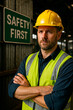 © Creative mind - An industrial worker posing with safety sign for the concept of industrial safety.