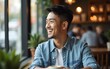 © Lucy - Asian handsome man sitting happily looking out of the window in a cafe. Concept freelance and financial freedom. High quality