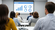 © MuhammadZeeshan - Business audience viewing presentation screen with charts and graphs, depicting corporate data analysis and professional learning environment.