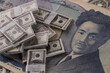 © Ruslan - Miniature Dollars Stacks on Japanese Yen Note
