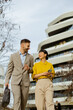 © BGStock72 - Business professionals walking and chatting outside a modern building in a city