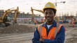 © Vasiliy - Confident African American construction worker smiling at a building site. Portrait of a young male engineer in a hard hat and safety vest with arms crossed