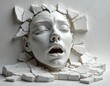 © miss irine - White cracked sculpted female face emerging from flat surface with open mouth, closed eyes conveying emotional distress breaking free. Studio shot of monochrome art. Broken pieces of plaster stone