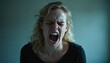 © miss irine - Young woman shouting, screaming with closed eyes, blonde hair disheveled. Angry female expression, emotional outburst, frustration, stress. Isolated on blue background, black shirt. Loud voice,