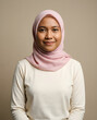 © ahmad - Portrait of a young woman wearing a light pink hijab and white top with a gentle smile in a