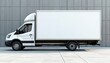 © miss irine - White cargo van parked on concrete with modern building backdrop. Blank side panel allows custom advertising placement for logistics and delivery companies promoting their brand.