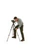 © julien.habis - A man adjusting the legs of a tripod on uneven ground