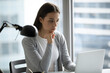© fizkes - Remote work reflection. Pensive young woman office worker corporate employee sit at desk think on effective solution analyze online data read electronic document review digital charts on laptop screen