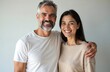 © Viktor - Mature happy couple smiles close together. Man has grey beard, woman has dark hair. They pose for photo indoors, showing affection and togetherness.