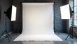 © Viktor - Photo studio setup with blank white backdrop and professional softbox lighting equipment on tripods. Ready for creative photo shoot with no people. Indoor scene.