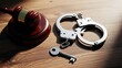 © Deloar - Symbols of justice: a judge's gavel and handcuffs with key on a dark wooden background