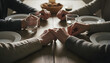 © Jumain - Close-up of family members holding hands at a dinner table, praying or showing unity before a meal, conveying concepts of gratitude, faith, and togetherness.