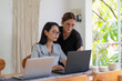© Ibenk.88 - Two Asian Women Working Together in a Bright Minimalist Workspace