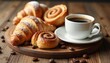 © Vadym - Freshly baked croissants, cinnamon rolls rest on wooden board next to steaming cup of black coffee. Coffee beans scatter across rustic table surface, creating warm, inviting breakfast scene.
