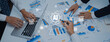 © InfiniteFlow - Business professionals collaborate on data analysis and chart discussions with advanced technology, highlighting teamwork and strategy in a modern office environment. Trope
