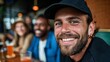 © iuricazac - Man smiling at camera, beard, sunglasses, hat, tattoo, casual attire, friends, bar, beer, indoor, group, celebration, leisure, enjoyment, socializing, outdoor, party, friends, gathering, social event