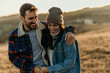 © La Famiglia - Happy couple enjoying autumn outdoors embracing love