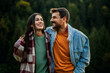 © La Famiglia - Happy young couple smiling together in nature