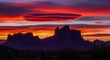 © Kenny - Dramatic sunset casts fiery hues over silhouetted desert mountain landscape serene vista