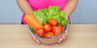 © Natee Meepian - Healthy Eating. Woman holding fresh vegetables in a bowl, promoting wellness and nutrition.