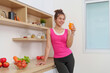 © Natee Meepian - Refreshing Drink. Woman enjoying healthy juice in modern kitchen.
