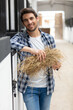 © auremar - portrait of cheerful man standing at a stable