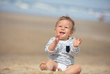 infant child sat on the beach