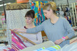 © auremar - two women shopping together in fabric shop