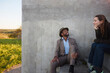 © Johnér - Smiling man in suit talking with woman while sitting on steps
