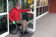 © Alex - A man in a wheelchair walks out of a door