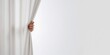 © AkuAku - A human hand pulling open a blank curtain revealing an empty space, used as a background for text and layout