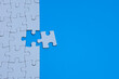 © faiz - Corporate Merger and Acquisition Concept with White Puzzle Piece and Blue Copy Space