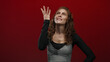 © Krakenimages.com - Woman gesturing locking lips stands confidently against a vibrant red background, symbolizing secrecy and privacy through expressive nonverbal communication.