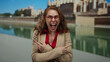 © Krakenimages.com - Woman in red glasses expressing surprise on a city street by a waterfront showcasing vibrant reactions.