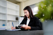 © Stella 16 - businesswoman using a calculator to calculate the numbers for financial document, finance accounting concept