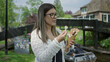 © Krakenimages.com - Woman enjoying ice cream in giethoorn netherlands with scenic canals in the background under a clear sky highlighting a casual outdoor leisure moment.