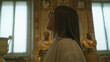© Krakenimages.com - Woman looking up at ornate museum ceiling wearing glasses with profile face beside classical busts and tall windows; quiet wonder.