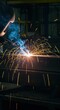 © Kathy - Intense industrial fabrication scene captured as powerful electric arc welding fuses heavy metal beams, generating bright shower of sparks ,large scale ,beams ,construction