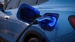 © musab - Electric vehicle charging close up detail shot showing glowing blue charging port connected with cable concept of sustainable future energy and modern transportation technology