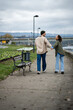 © Zoran Jesic - Couple walking and laughing holding hands in park