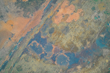  Aerial top down view of complex marshland texture with blue pools and orange vegetation. Abstract nature background and war zone landscape art.