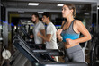© JackF - Woman runs on a treadmill in the gym. European woman performs cardio zone training