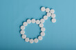© Mulad Images - Male gender sign made from medical pills on blue background. Men’s health, fertility, treatment, and healthcare concept.