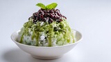 Flat lay of Japanese kakigori shaved ice dessert topped matcha syrup and red bean paste placed on plain white background