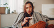 © peopleimages.com - Sick, woman and thermometer in home for virus infection, influenza or allergy on living room sofa. Girl, winter and fever with high temperature in lounge, cold or medical health problem with blanket