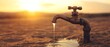 © hsantima - An outdoor tap with water flowing at sunset.
