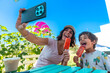 © unai - Mother and son taking a selfie while enjoying ice cream on a sunny day