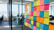 © Ohetod - Colorful sticky notes meticulously arranged on a modern office glass wall, creating a vibrant mosaic that symbolizes agile brainstorming and collaborative strategy.