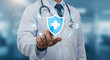 © ROKEYAGPRO - Doctor holding a glowing shield with a medical cross symbolizing healthcare protection