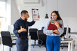 © Pixel-Shot - Stressed female worker with folders and her angry boss in office